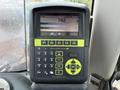 A digital display panel showing weight measurements and product information on a Doosan DL300-5 loader