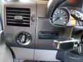 The interior dashboard of a 2016 Mercedes-Benz Sprinter featuring air conditioning vents a speedometer and control knobs