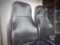 Two black leather seats with vertical stitching in a 2008 Freightliner MT45 Chassis