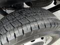 Close-up of a tire from a 2018 Ford Transit showing deep treads and wear patterns