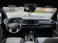 Interior view of a 2022 Toyota Tacoma showing the steering wheel dashboard and center console with an infotainment screen