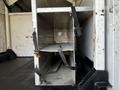 Interior storage compartments of a 2008 Ford F-550 with metal shelves secured by straps