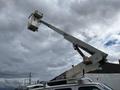 A 2008 Ford Econoline equipped with a raised bucket and extension arm for elevated work
