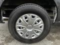 A close-up of a 2020 Ford Transit wheel showcasing a silver metallic rim with a unique spoke design and a black tire with visible tread patterns