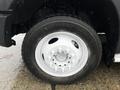 Close-up of a white wheel and tire of a 2014 Ford F-550 showing tread and wheel design