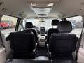 Interior view of a 2017 Dodge Grand Caravan showing rear seating area with black leather seats and a central console