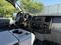 Interior view of a 2014 Ford F-250 SD showing the dashboard steering wheel and center console with various controls and a key in the ignition