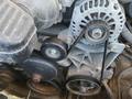 Close-up of the engine components of a 2013 Chevrolet Silverado 1500 featuring a belt system with pulleys and an alternator.