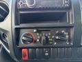 The dashboard control panel of a 2014 Hino 195 featuring climate controls a CD player and various dials and buttons for air conditioning and ventilation