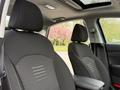 Interior view of a 2021 Kia Forte showcasing two front seats with black fabric upholstery and headrests