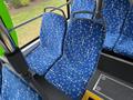 Two blue patterned seats inside a 2018 Grande West Vicinity bus with grey armrests