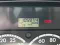 The dashboard display of a 2012 Freightliner M2 112 showing trip miles as 13.9 and total hours as 10597.4 with a red warning light illuminated