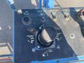 Control panel of a 1997 Genie S-65 4X4 featuring various knobs and switches for operating the lift's functions