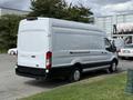 A white 2021 Ford Transit van with a high roof and cargo area visible from the back and side