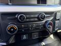 The image shows the interior control panel of a 2024 Ford F-550 featuring climate controls volume and tuning buttons
