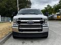 A 2020 Ford F-350 truck with a chrome grille and bold front fascia parked on a road