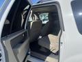 Interior view of a 2013 Ford Expedition showing rear seats and door open with a water bottle on the floor