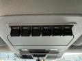 Overhead control panel in a 2023 Ford F-550 featuring six auxiliary switches labeled AUX 1 through AUX 6