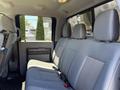 Interior of a 2014 Ford F-250 SD featuring gray fabric seating with two rows of seats and seatbelts visible on the right side