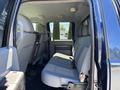 Interior view of the back seat of a 2014 Ford F-250 SD featuring gray upholstery and spacious seating