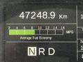 A digital display showing the mileage of 47248.9 km and a fuel economy gauge with green bars indicating average fuel efficiency