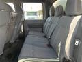 Interior view of a 2015 Ford F-450 SD showing the backseat with gray fabric upholstery and seating for three passengers