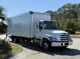 A white 2020 Hino 268 box truck with a shiny chrome front and large cargo area