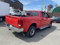 Red 2012 RAM 2500 pickup truck with four doors and a truck bed visible in the foreground