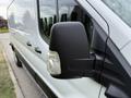 A side view of a 2022 Ford Transit featuring a black exterior mirror with an integrated turn signal light