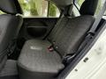 Interior view of a 2013 Mitsubishi i-MiEV showing the rear bench seat with dark fabric upholstery and seatbelts