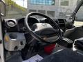 Interior view of a 2018 Hino 195 showing the steering wheel dashboard and gear shift with various controls and gauges