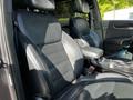 Interior of a 2017 Kia Sorento featuring black leather seats with a sporty design and a central console with cup holders