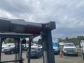 A 2010 Toyota 7FGGU25 forklift showcasing its front with a clear view of the hydraulic mast and attachment points