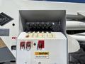 A control panel with multiple switches and buttons for operating a lift, featuring caution signs and labeled functions