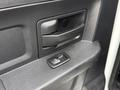 Close-up of the door handle and window control button on the interior door panel of a 2013 RAM 3500