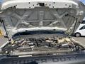 A 2015 Ford F-450 SD with the hood raised revealing the engine compartment and various mechanical components