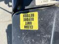 A yellow sticker on a black surface reads CLEAN UNIT BEFORE RETURN