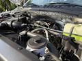 A close-up view of the engine compartment of a 2022 Ford F600 showcasing various components and tubing under the hood