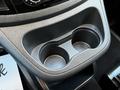 A close-up view of the cup holder area in a 2022 Mercedes-Benz Metris featuring two circular indentations for cups