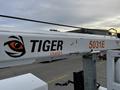 A 2016 Ford F-550 truck with a crane attachment displaying the logo of Tiger Cranes and the model number 5031E