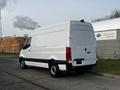 A white 2022 Mercedes-Benz Sprinter van parked with a high roof and no visible branding on the side