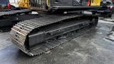 A 2018 Caterpillar 326F L Excavator tracks featuring a sturdy metal frame and large rubber treads designed for stability and traction on various surfaces
