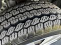 A close-up of a tire from a 2017 Nissan NV200 showcasing its tread pattern and rubber texture