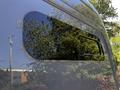 Close-up of the side of a 2017 Mercedes-Benz Sprinter showing a sleek design with a window and reflective surface