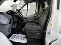 Interior of a 2017 Ford Transit showing two front seats and the dashboard with a steering wheel and controls