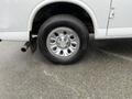 A close-up of the wheel of a 2012 Chevrolet Express showing a shiny chrome rim and a black tire with the Michelin logo