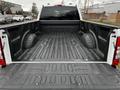 The image shows the open bed of a 2020 Ford F-350 SD featuring a textured spray-on liner and built-in wheel well pockets