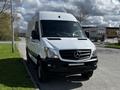 A white 2017 Mercedes-Benz Sprinter van positioned at an angle with a sleek front and prominent star logo on the grille