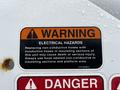 Warning label on an International DuraStar truck indicating electrical hazards and safety instructions for replacing hoses