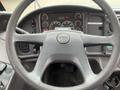 The image shows the steering wheel and dashboard of a 2007 Freightliner B2 featuring gauges and control buttons